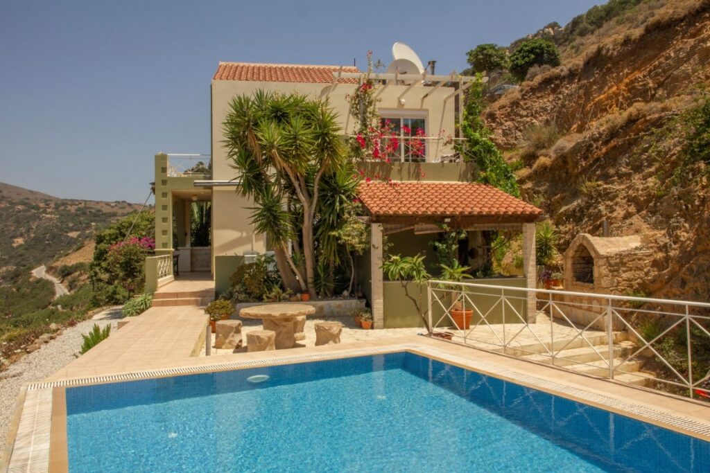 A VILLA PERCHED ON THE SEAFRONT HILLSIDE OF RAVDOUCHA