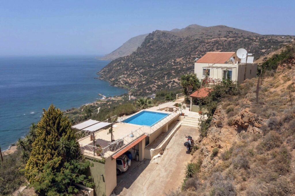 A VILLA PERCHED ON THE SEAFRONT HILLSIDE OF RAVDOUCHA