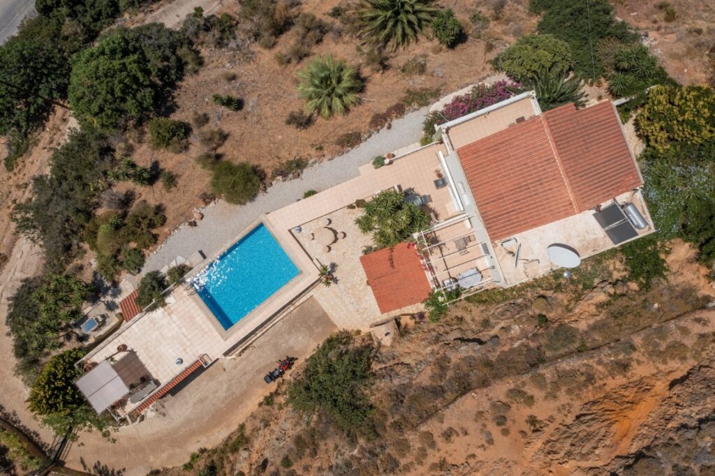 A VILLA PERCHED ON THE SEAFRONT HILLSIDE OF RAVDOUCHA