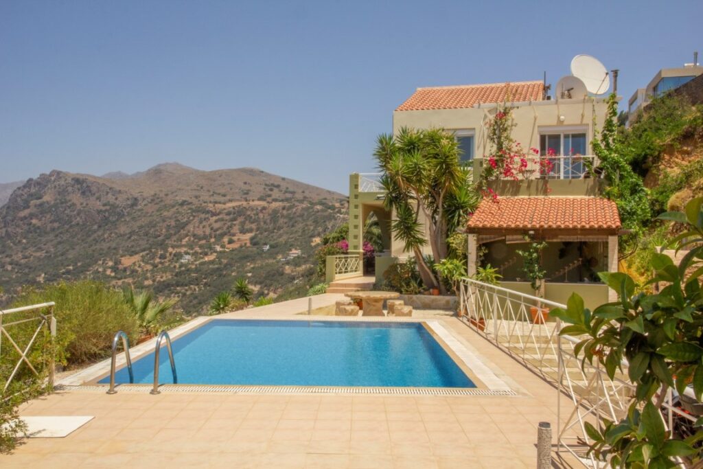 A VILLA PERCHED ON THE SEAFRONT HILLSIDE OF RAVDOUCHA