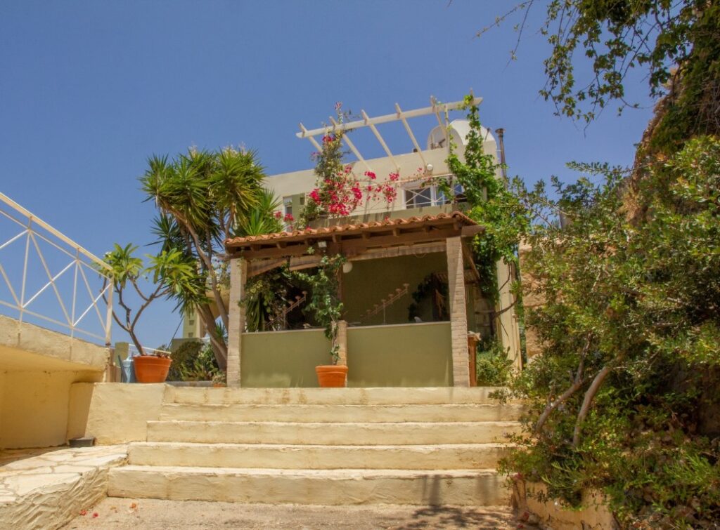 A VILLA PERCHED ON THE SEAFRONT HILLSIDE OF RAVDOUCHA