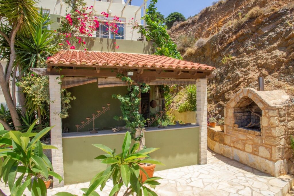 A VILLA PERCHED ON THE SEAFRONT HILLSIDE OF RAVDOUCHA