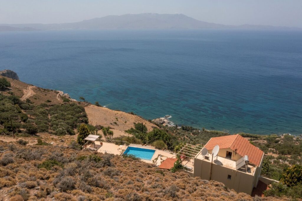 A VILLA PERCHED ON THE SEAFRONT HILLSIDE OF RAVDOUCHA