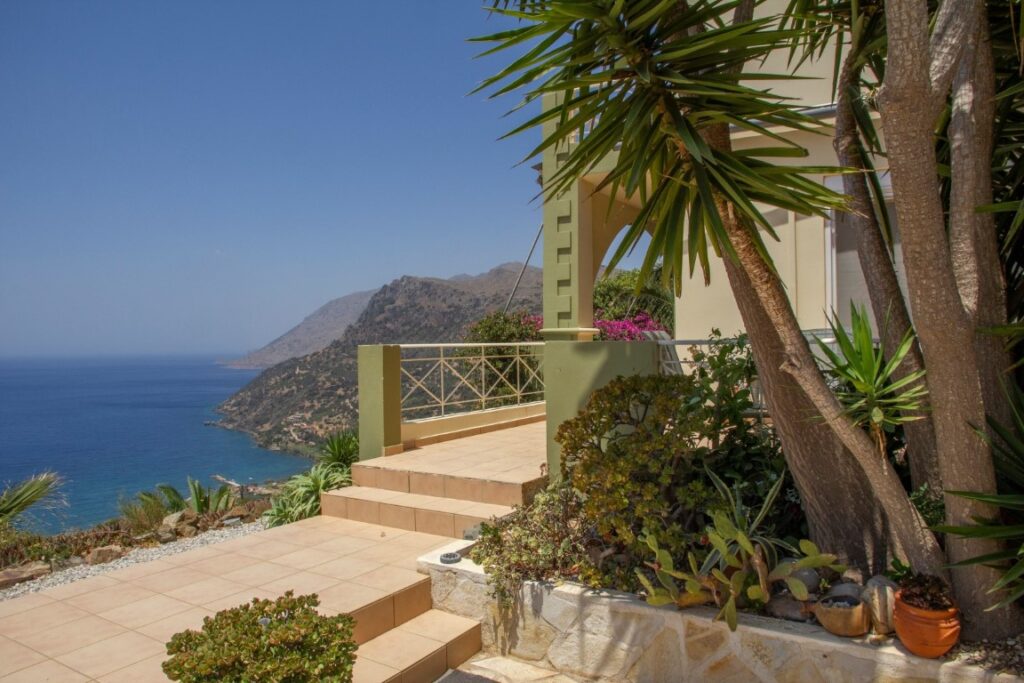 A VILLA PERCHED ON THE SEAFRONT HILLSIDE OF RAVDOUCHA