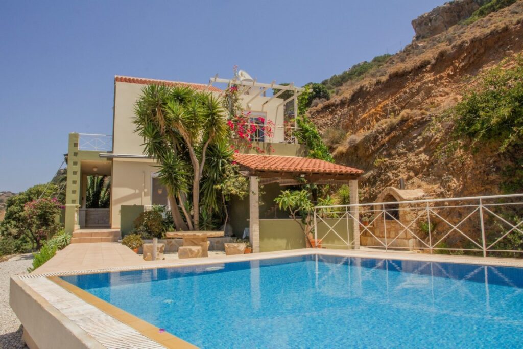 A VILLA PERCHED ON THE SEAFRONT HILLSIDE OF RAVDOUCHA