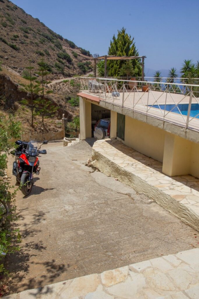 A VILLA PERCHED ON THE SEAFRONT HILLSIDE OF RAVDOUCHA